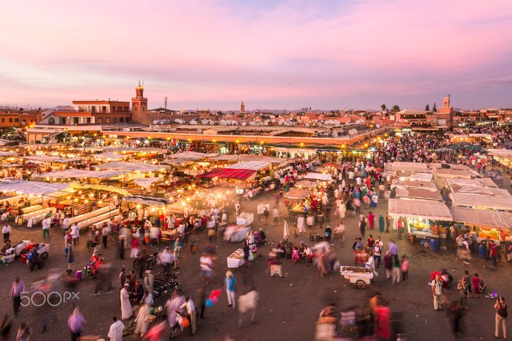 an aerial view of a crowded market place at dusk