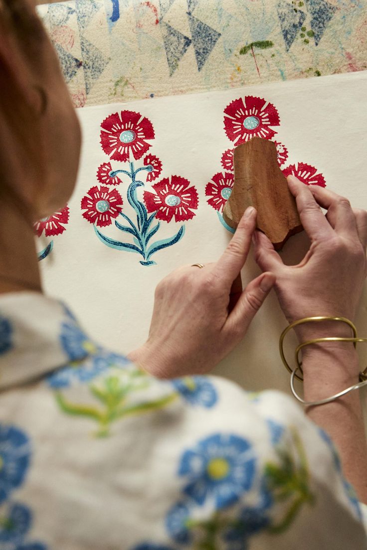 a woman is working on an art project