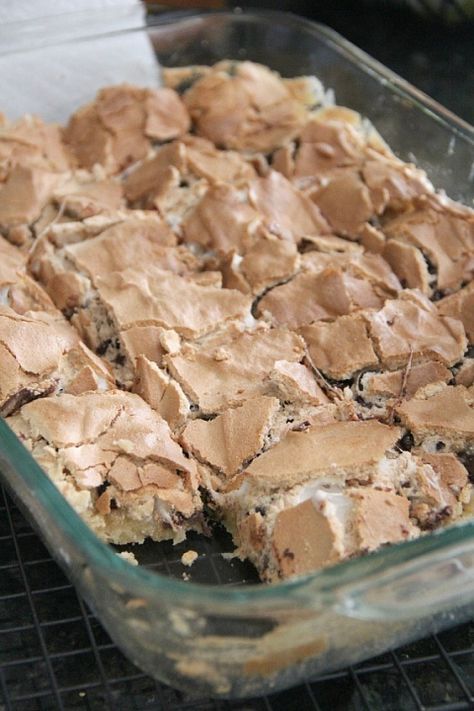 a glass baking dish filled with brownies and marshmallows