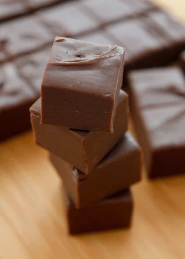 several pieces of chocolate sitting on top of a wooden table next to another piece of chocolate