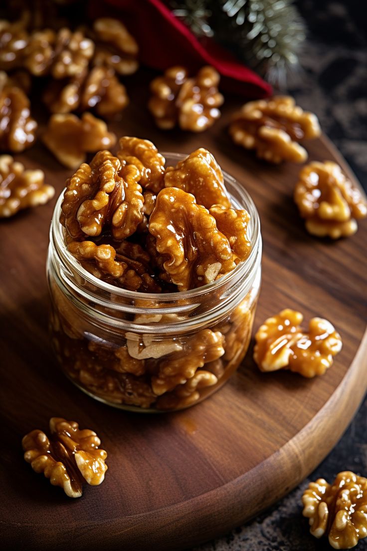 a jar filled with caramel pretzels on top of a wooden cutting board