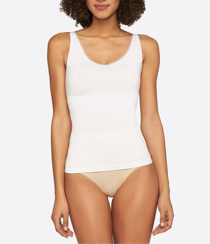 From the Seamless Shape collection by Yummie by Heather Thomson&#x2C; this tank features:ultra-light temperature-controlling fabricpicot trimV-neckline and scoop back for reversible wearbuilt-in shelf braTencel /Outlast nylon/spandexmachine washImported. White Seamless Scoop Back Top, White Seamless Top With Scoop Back, White Seamless Tops With Scoop Back, Shaping Scoop Neck Tank Top With Built-in Bra, Scoop Neck Tank Top With Minimal Stretch, White Seamless Stretch Vest, White Seamless Tank Top With Minimal Stretch, Compressive Seamless Cami Tank Top, Compressive Seamless Tank Top With Wide Straps