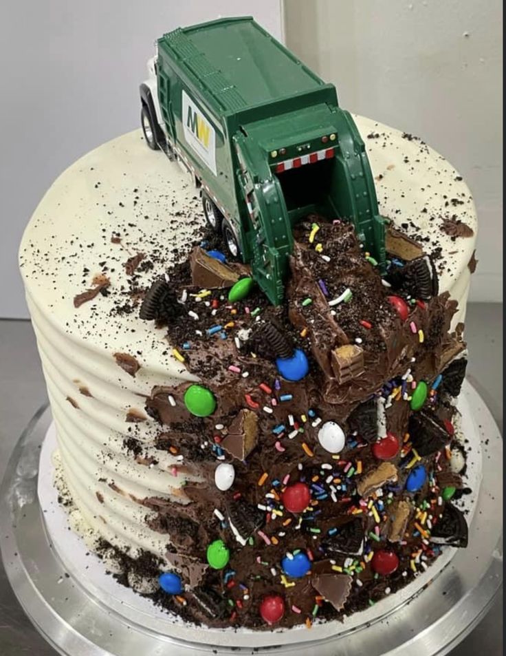 there is a cake that has a truck on it and lots of sprinkles