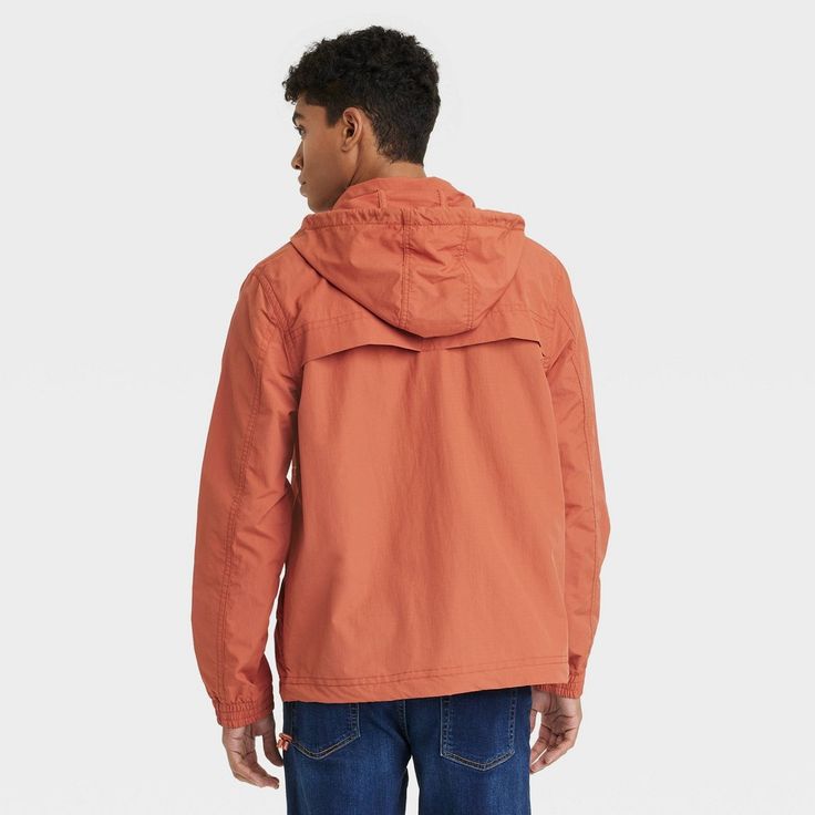 Refresh your wet-weather staples with this Elevated Rain Jacket from Goodfellow & Co™. This stylish elevated jacket in a solid orange color makes a versatile pick for rainy days. Made from water- and wind-resistant material, this hooded jacket features a lightweight construction to keep you dry, warm and comfortable at all times. The full-length zipper and snap closures allow for easy layering, while the elastic cuffs provide a snug fit. Plus, the front pockets allows you to carry small essentia Solid Orange Color, Solid Orange, Shipt Shopper, Wet Weather, Fabric Tape, Mesh Material, Mens Big And Tall, Big And Tall, Big & Tall