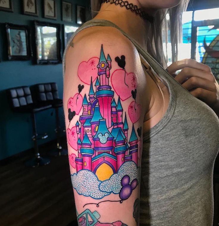 a woman with a castle tattoo on her arm