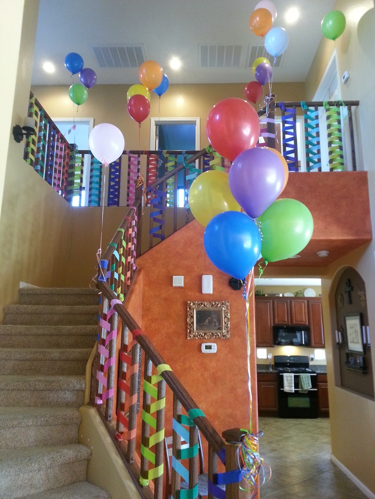 the staircase is decorated with balloons and streamers