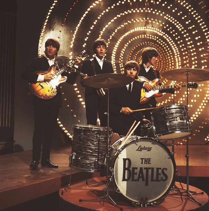 the beatles on stage with their instruments