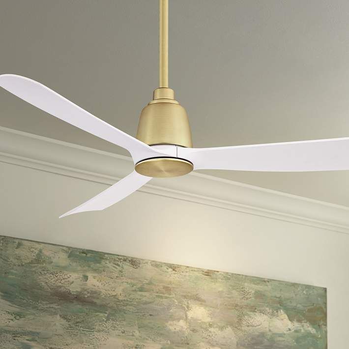 a white ceiling fan with a light on top of it in a room next to a painting