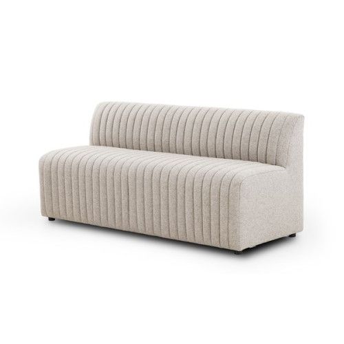 a white couch sitting on top of a white floor