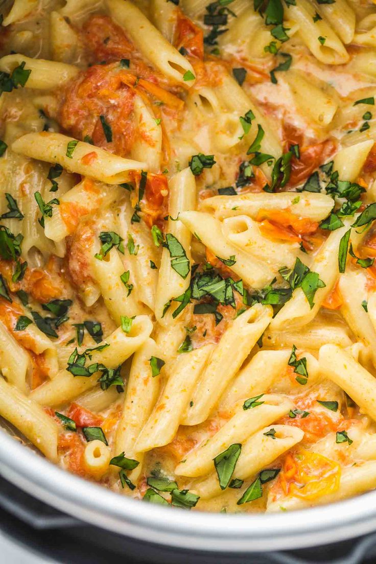 pasta with tomato sauce and parsley in an instant pot on the stove, ready to be cooked