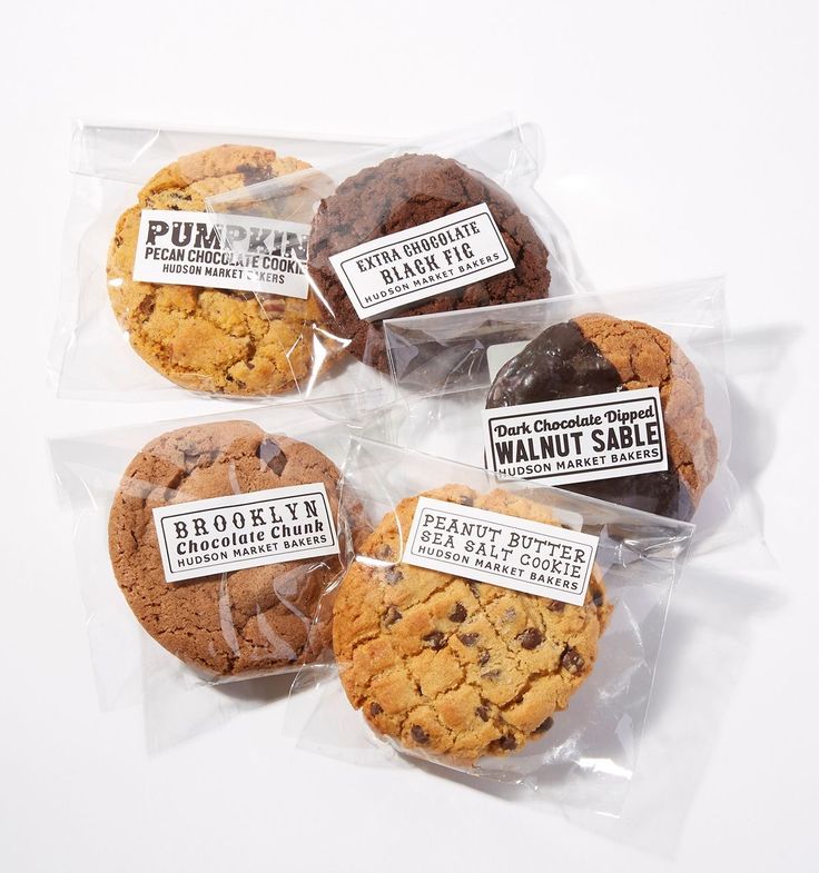 four packaged cookies in plastic bags with labels on them