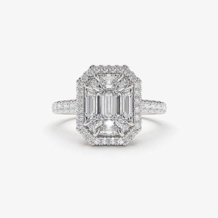 an emerald - cut diamond engagement ring set in 18k white gold with diamonds around the band