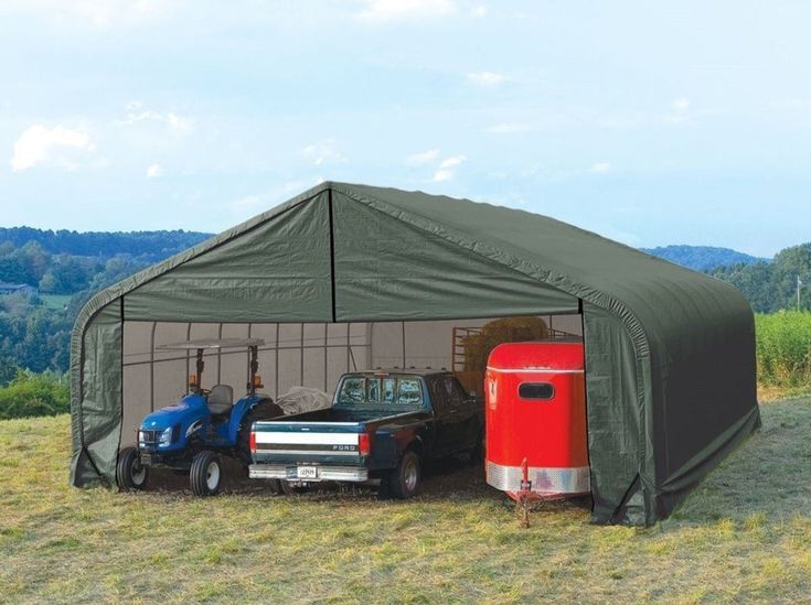 two trucks are parked in front of a tent