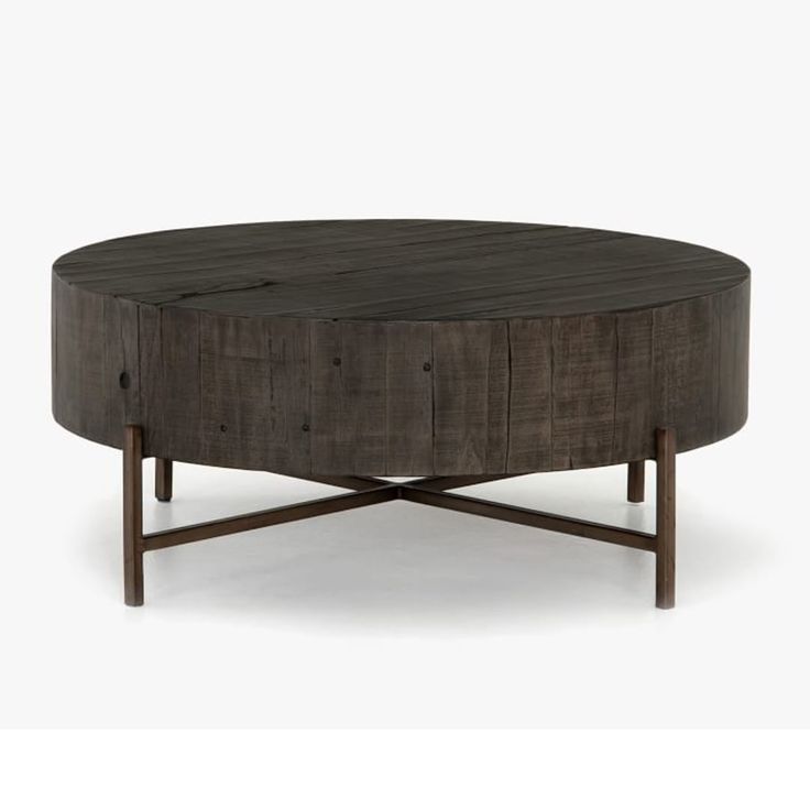 a round coffee table with wooden legs and a wood grained finish on the top