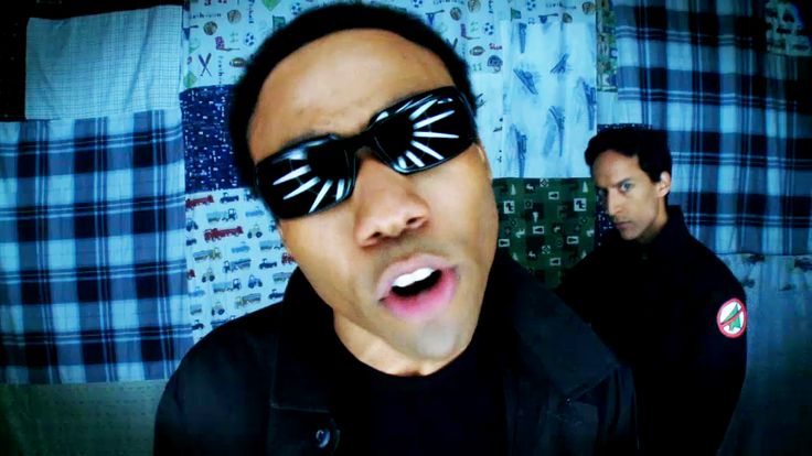 a man with sunglasses on his face and another man in the background making silly faces