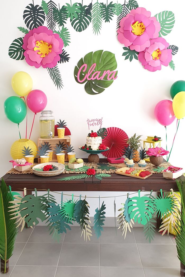 the table is set for two with balloons and flowers on it, along with other decorations