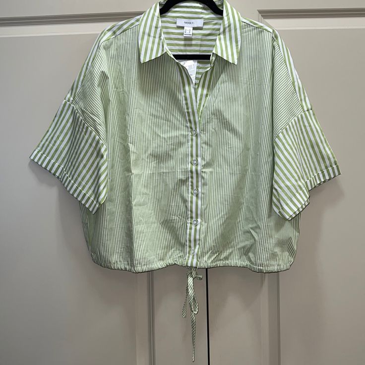 New Forever 21 Striped Shirt, Size 3x, Never Worn, Tags Still Attached, Colors Include Green & White, Button Down Shirt With String At Bottom For Option To Adjust At Waist, Has A Collar, 100% Cotton, Will Come From A Pet/Smoke Free Home Fyi, Can Be Cropped Based On Your Height Forever 21 Relaxed Fit Short Sleeve Tops, Forever 21 Green Tops For Spring, Forever 21 Short Sleeve Blouse For Day Out, Chic Green Top From Forever 21, Forever 21 Green Cotton Tops, Forever 21 Cotton Shirt For Spring, Forever 21 Collared Summer Tops, Forever 21 Shirt For Spring Day Out, Forever 21 Collared Tops For Summer