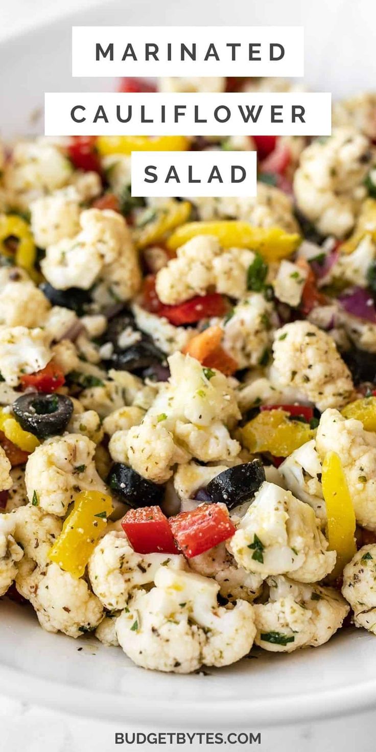 cauliflower salad in a white bowl with the words marinated cauliflower salad