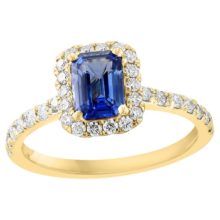 Showcases an emerald-cut blue sapphire weighing 1.06 carats, surrounded by a single row of 36 round brilliant diamonds in a seamless halo design. Set in a thin 14-karat yellow gold band accented with diamonds. Diamonds weigh 0.49 carats in total. Style is available in different price ranges. Prices are based on your selection of the 4C’s (Carat, Color, Clarity, Cut). Don't hesitate to get in touch with us for more information. Ruby Band Ring, Sapphire Diamond Engagement Ring, Diamond Sapphire Engagement Ring, Sapphire Diamond Engagement, Emerald Cut Diamond Engagement, Gold Solitaire Engagement Ring, Sapphire Band, Halo Design, Modern Engagement Rings