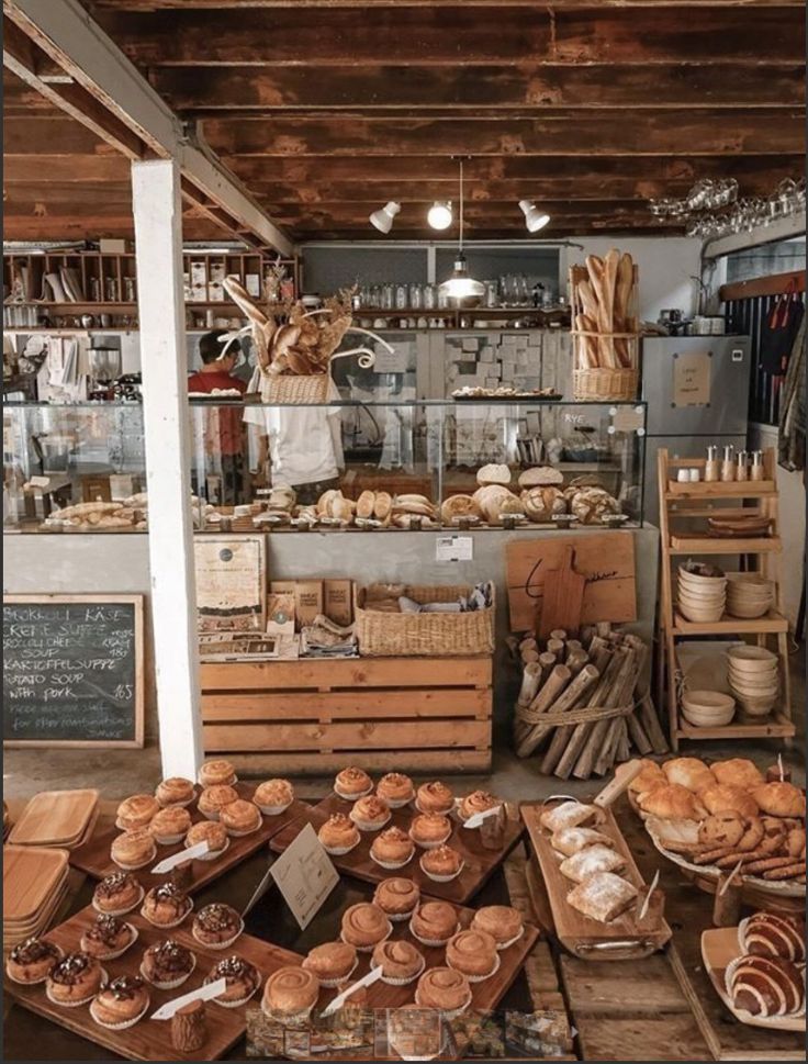 there are many baked goods on display in the store, including breads and muffins