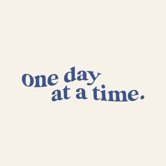 the words one day at a time written in blue ink