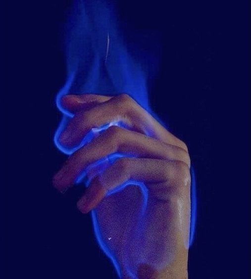 a person's hand is lit up with blue light