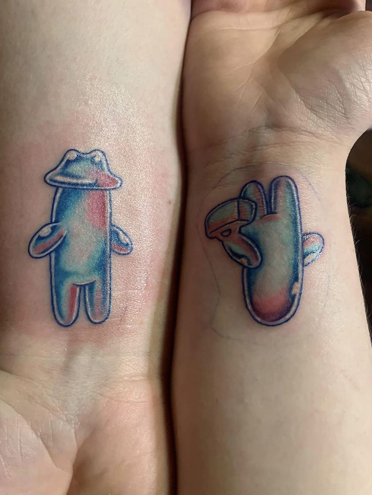 two people with matching tattoos on their arms