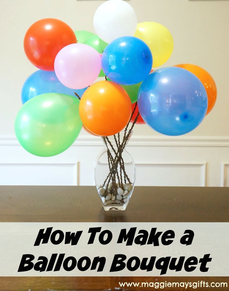 a vase filled with balloons sitting on top of a table