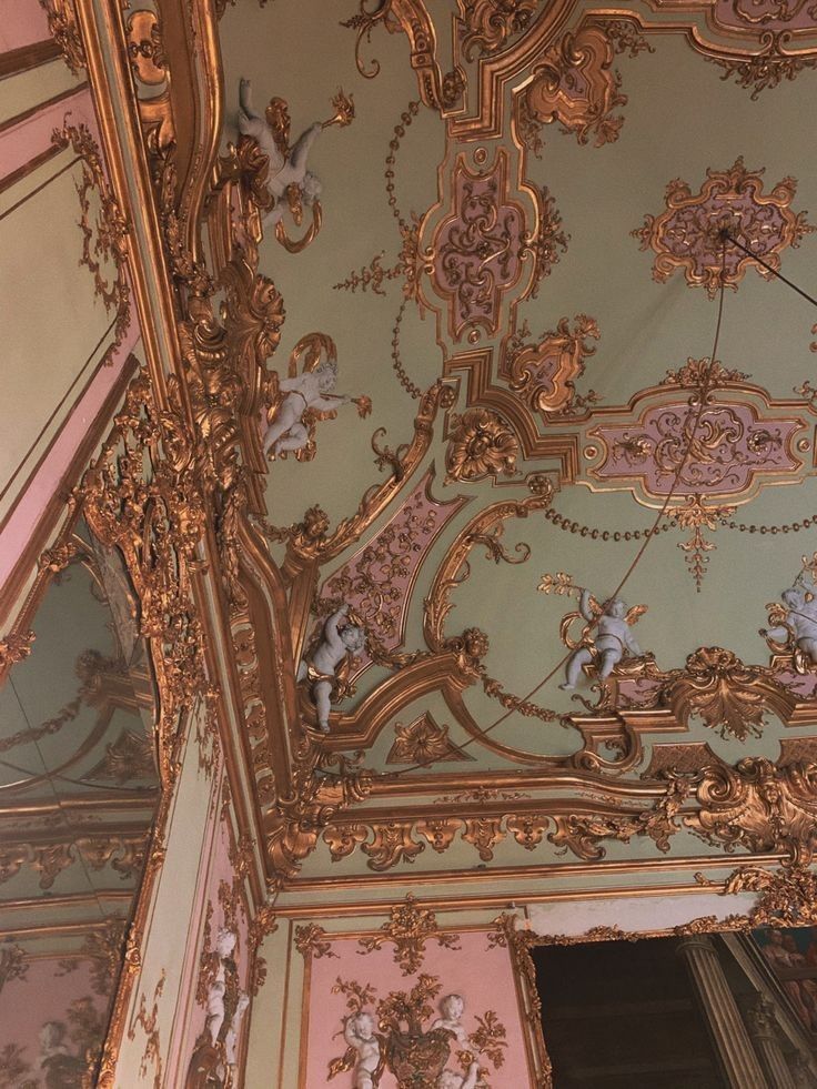 an ornately decorated ceiling in a pink and gold room