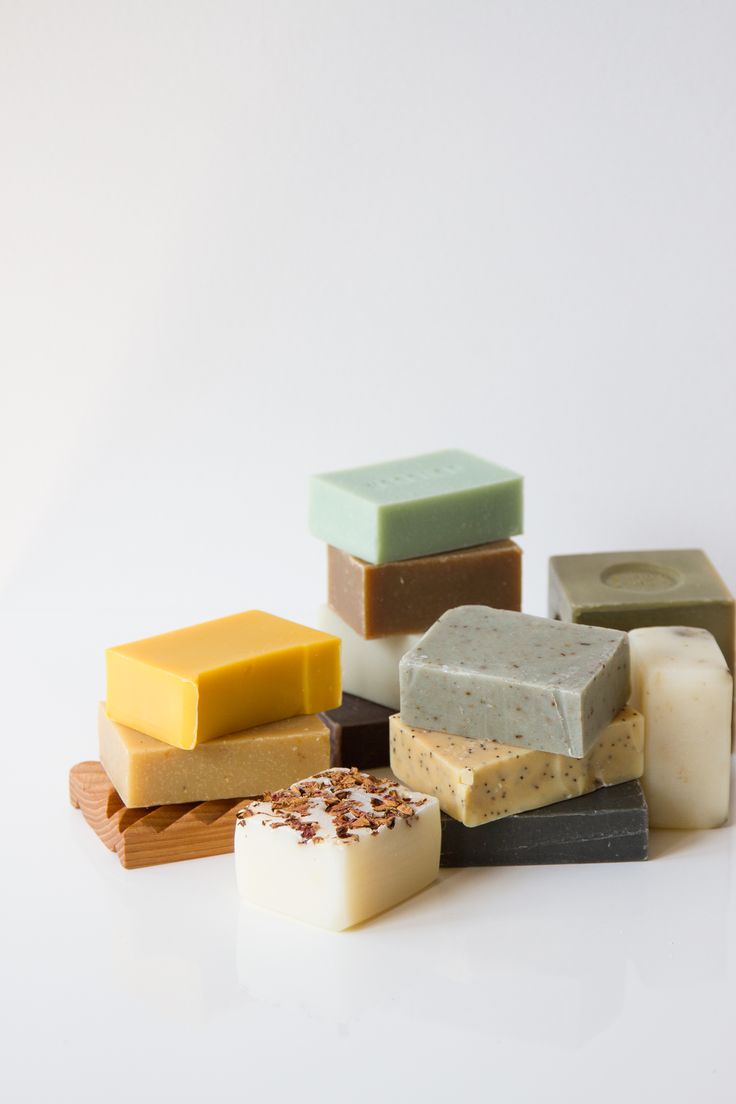 several different types of soaps sitting on top of each other in front of a white background