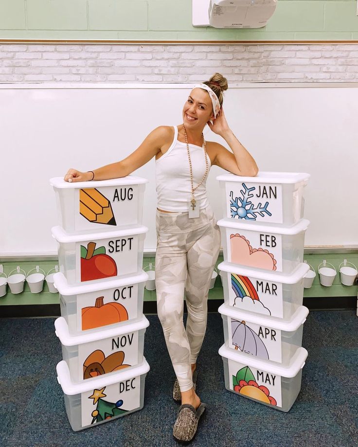 a woman standing next to stacks of plastic containers with different pictures on the lids and sides