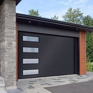 a black garage door on the side of a house