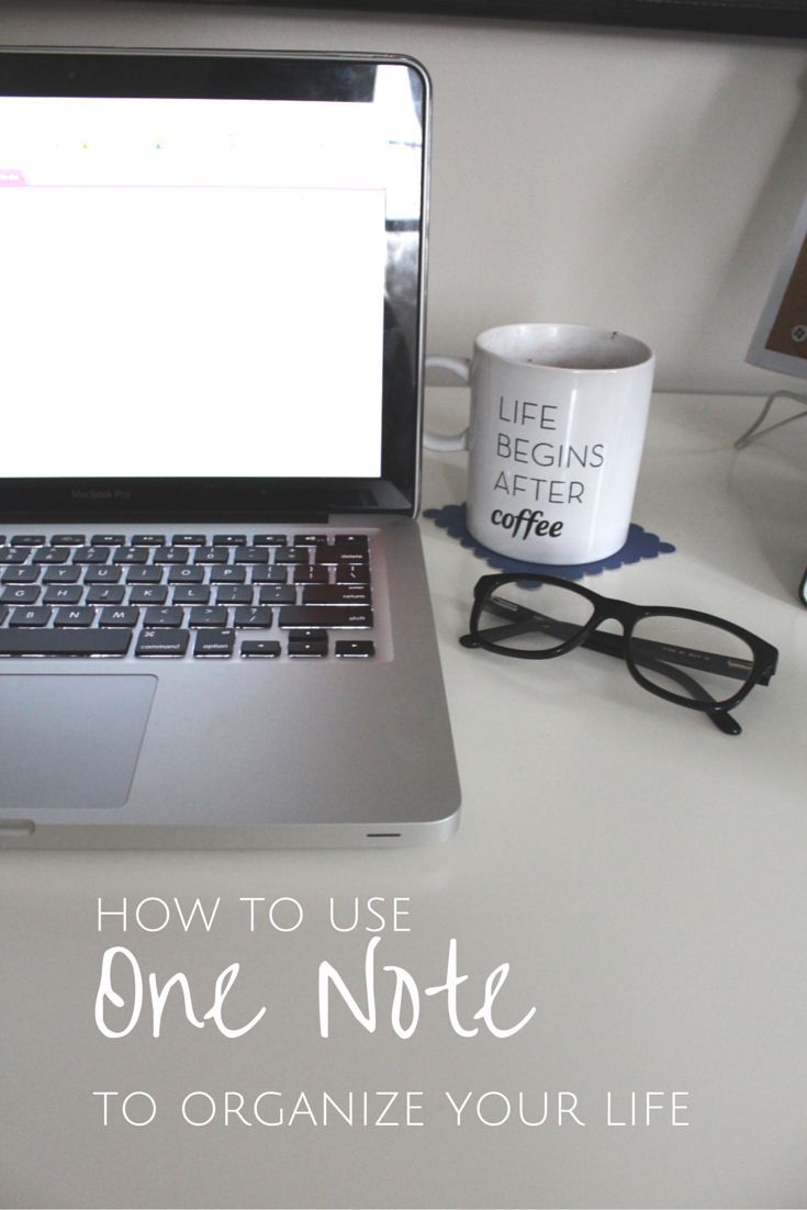 an open laptop computer sitting on top of a white desk next to a cup of coffee