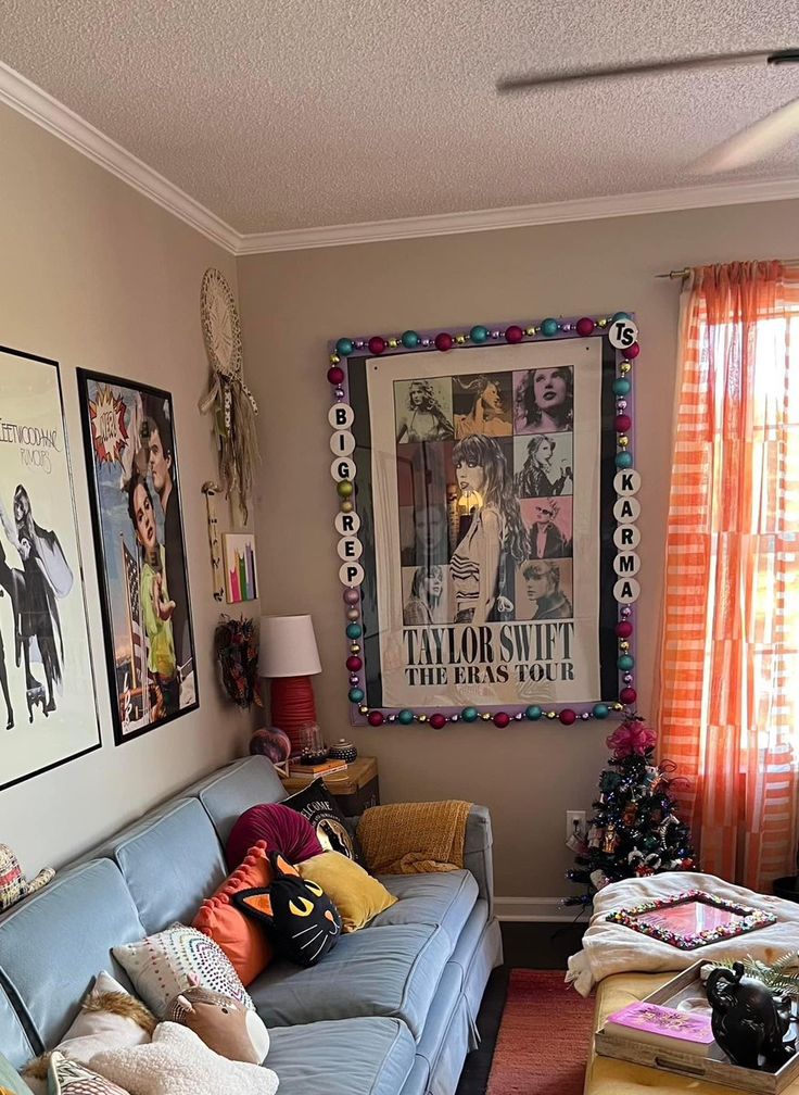 a living room filled with lots of furniture and pictures on the wall above it's windows