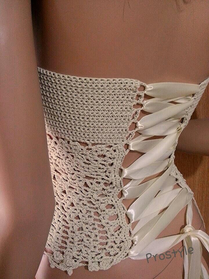 the back of a woman's bra with white crochet and ties on it