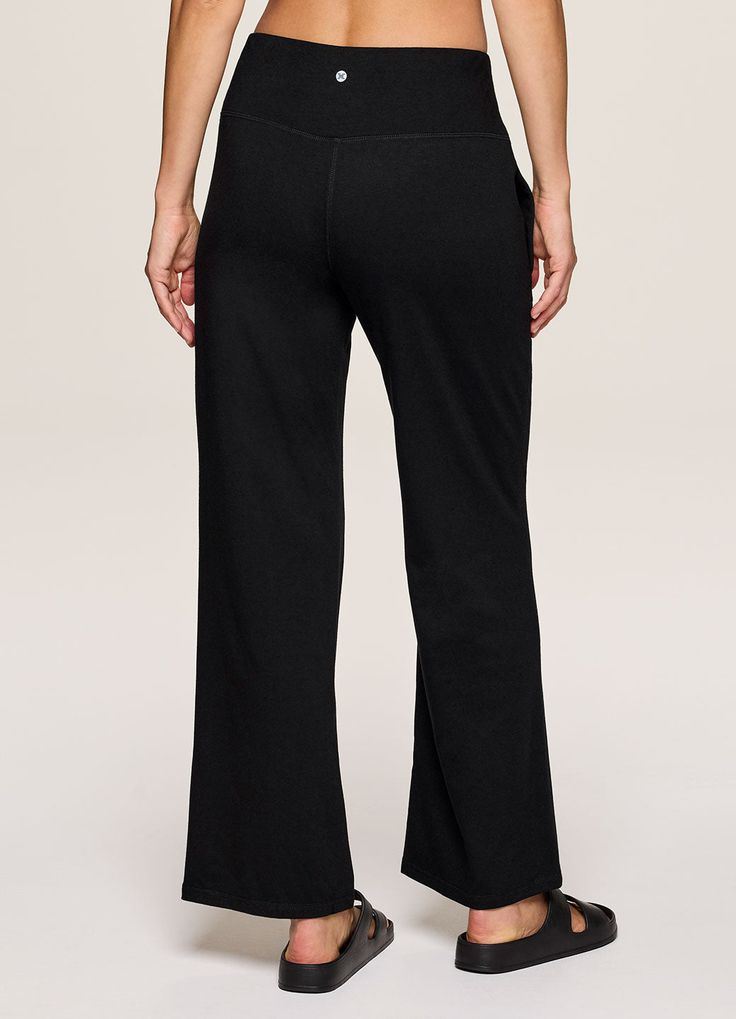 Whether you pair it with your favorite denim jacket or a sports bra for yoga, our Lotus Wide Leg Pant is the ultimate studio-to-street piece. A relaxed, wide leg design keeps you comfortable and on trend while the flat-front elastic waistband ensures an ultra flattering look and fit without sacrificing comfort. Complete with side pockets that provide the functionality you're looking for, you can unwind and reset in these versatile women's sweatpants. Sporty Black Wide Leg Pants For Spring, Casual Comfort Stretch Yoga Pants, Loosely Fitted Yoga Pants With Comfort Waistband, Relaxed Fit Sweatpants For Yoga, Relaxed Fit Athleisure Sweatpants For Yoga, Comfortable Yoga Pants With Ribbed Waistband, Black Cotton Comfort Stretch Sweatpants, Black Wide Leg Yoga Pants With Comfort Stretch, Versatile Black Mid-rise Bottoms