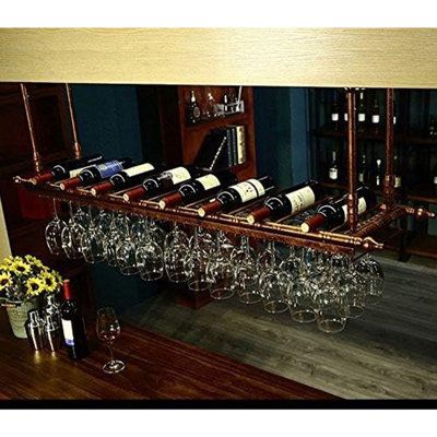 a wine rack filled with lots of bottles and glasses on top of a wooden table