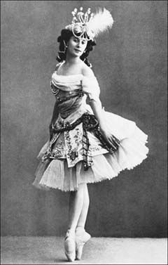 an old fashion photo of a woman in a tutu skirt and headdress