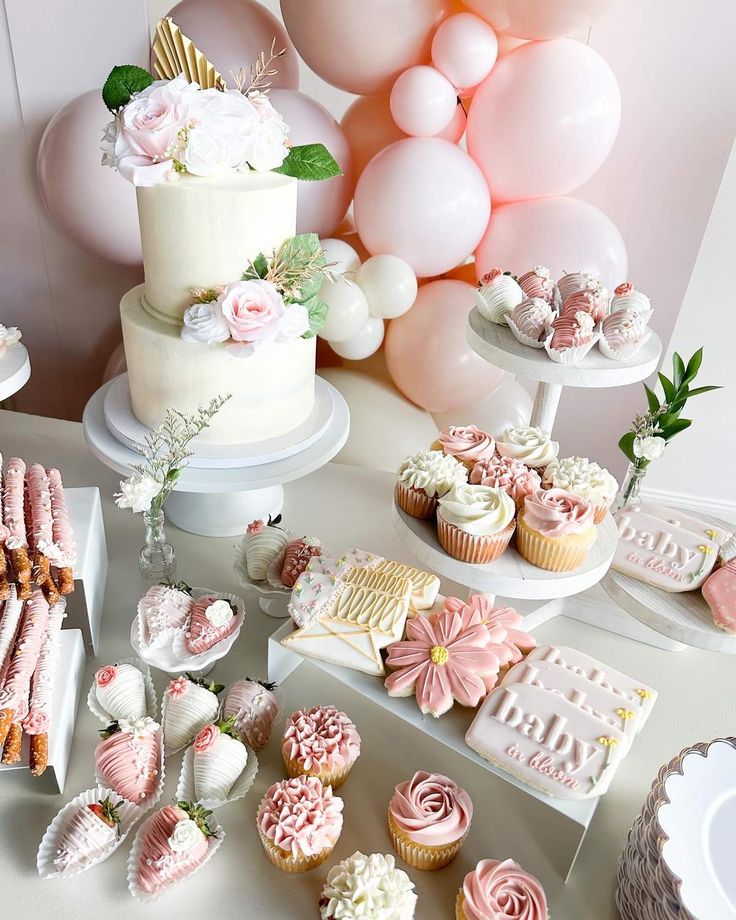 a table topped with lots of cupcakes and cakes