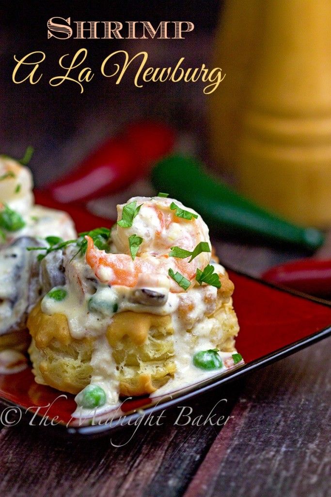 shrimp and pea cakes on a red plate with green garnishes in the background