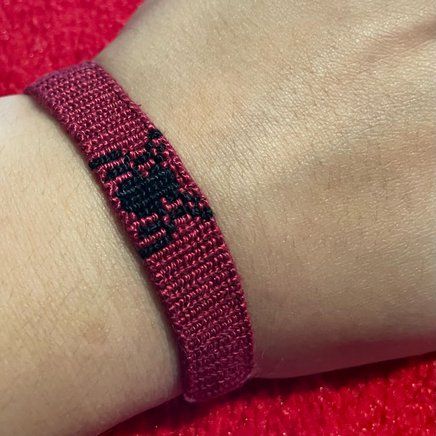 a close up of a person's wrist wearing a bracelet with an elephant on it