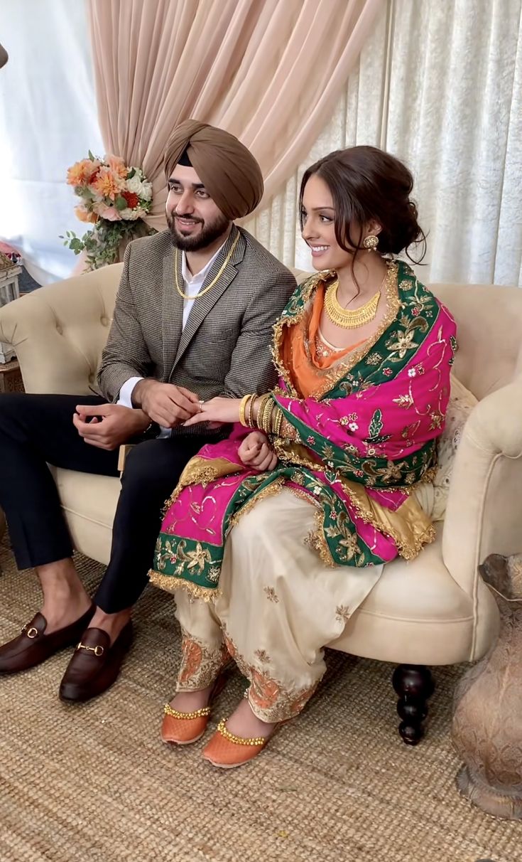 a man and woman sitting on top of a couch