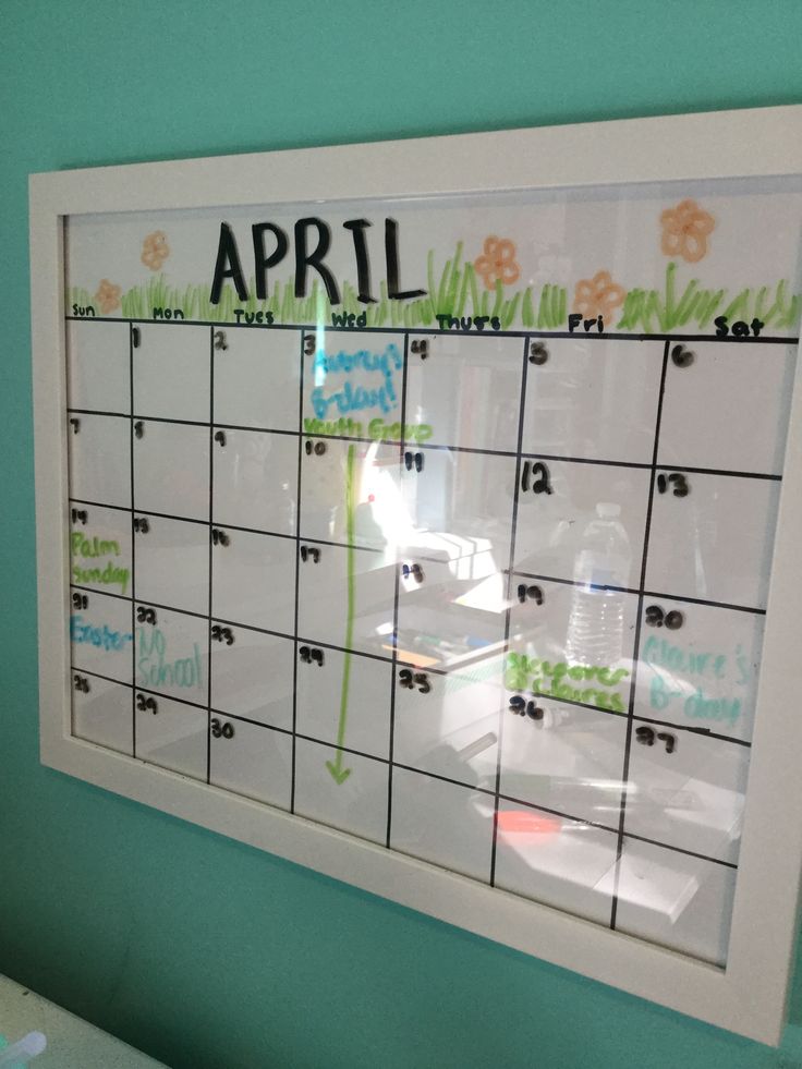 a calendar with writing on it is hanging on the wall