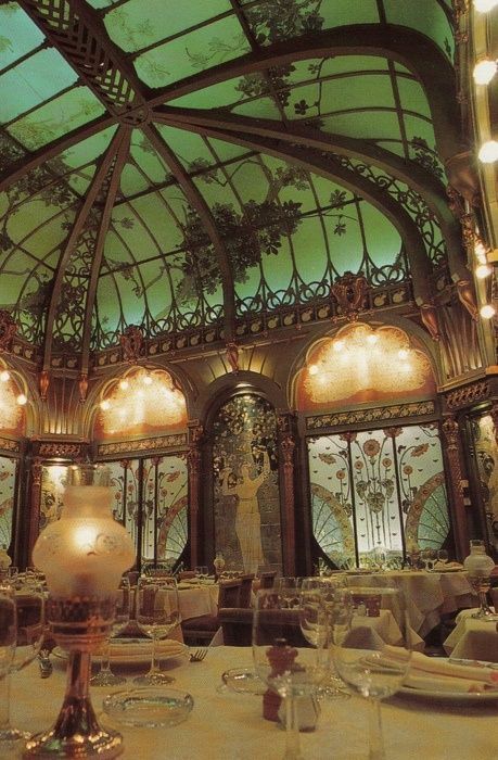 a fancy dining room with glass ceiling and chandelier