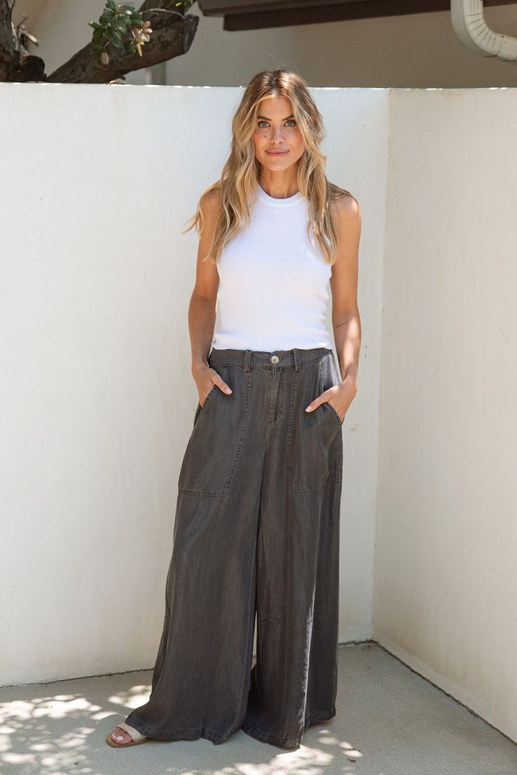 Look good and feel good in the Clarke Tencel Pants! Designed to feel like butter against your skin, these pants feature a stylish wide leg and a finished hem, offering a relaxed fit that moves with you. The Tencel fabric ensures exceptional comfort and a cooling sensation, making them perfect for those hot summer days. FINAL SALE- No returns or exchanges FIT Easy Relaxed Fit Stretchy Waistband Pockets Zipper Fly Pockets Finished Hem Britt is 5'9 Wearing Size Small SIZE SMALL MEDIUM LARGE LENGTH Relaxed Wide-leg Fall Pants, Relaxed Wide-leg Bottoms For Fall, Relaxed Wide Leg Fall Pants, Relaxed Wide Leg Bottoms For Fall, Relaxed Wide Leg Parachute Pants With Pockets, Relaxed Wide-leg Pants For Fall, Chic Wide-leg Everyday Pants, Chic Wide-leg Pants For Everyday, Everyday Wide Leg Pants For Fall