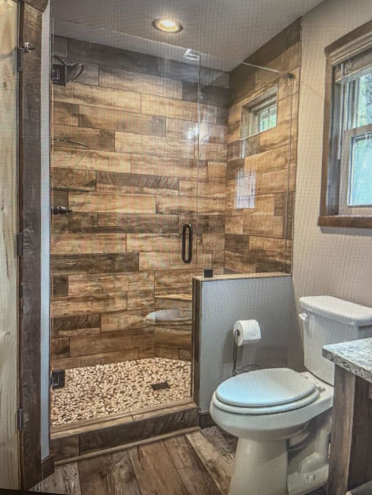 a bathroom with a shower, toilet and sink in it's center area is shown