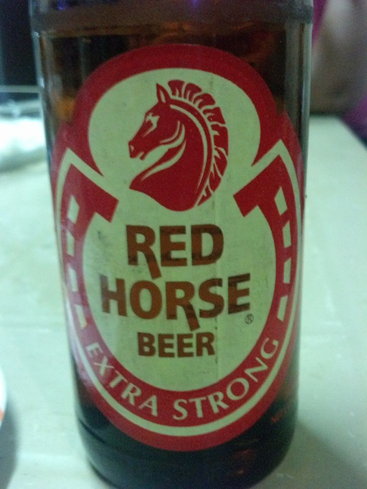 a bottle of red horse beer sitting on top of a table