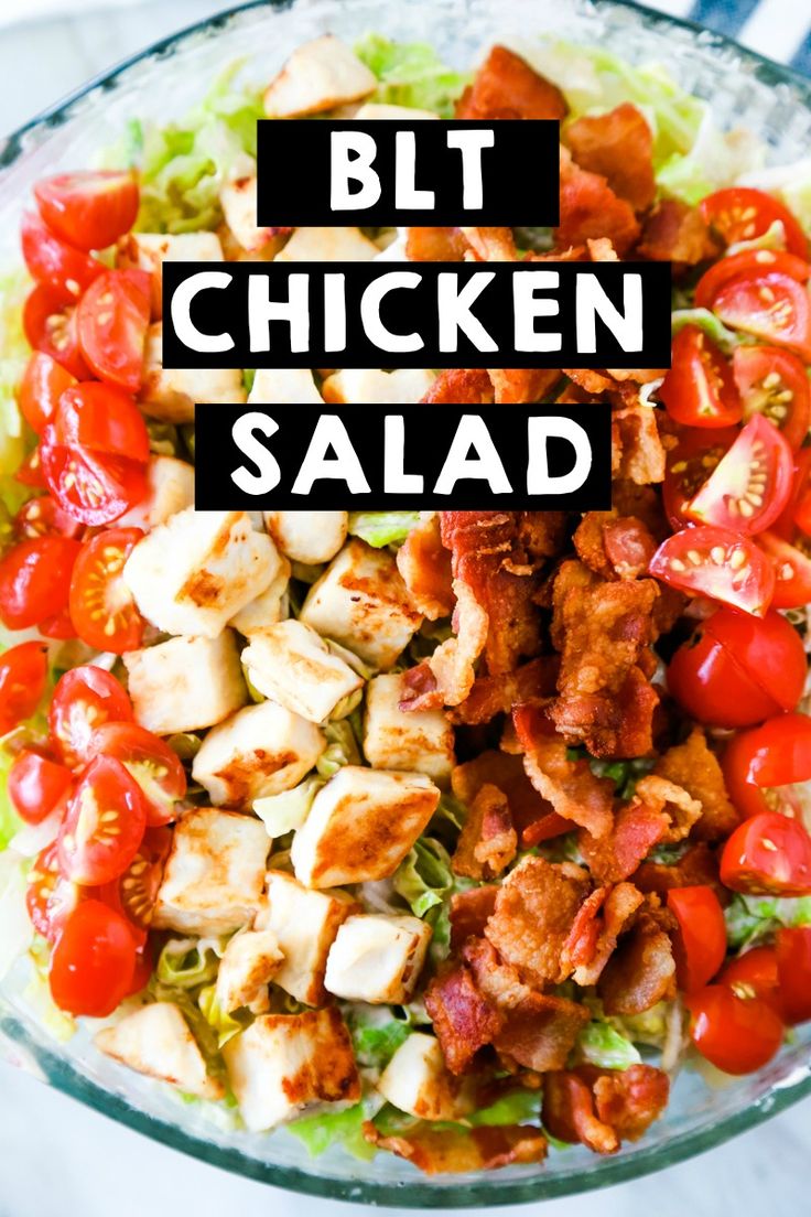 chicken salad with lettuce and tomatoes in a glass bowl