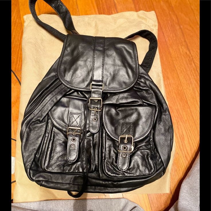 Backpack Soft Black Leather All Zippers Snaps Clips And Drawstrings All In Working Condition. In Perfect Condition And Comes With Its Own Protective Bag To Store It In. Nwot Never Been Used. All Items Come From A Pet And Smoke Free Home. Thank You For Looking! Keep Smilin’ Black Leather Backpack With Zipper Pocket, Black Leather Backpack For On-the-go, White Sling Bag, Black Jansport, Black Soft Leather Backpack For On-the-go, Small Backpack Black, Black Leather-lined Standard Backpack, Beige Backpacks, Black Leather Backpack With Removable Pouch For On-the-go