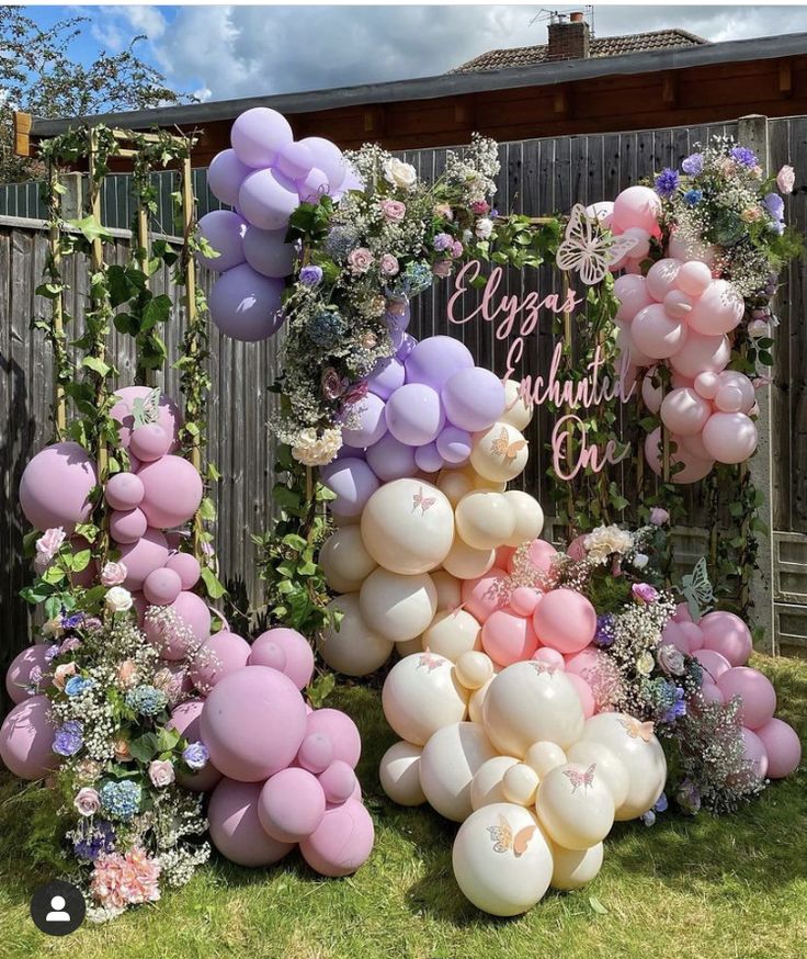 some balloons and flowers are on the grass